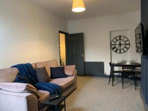 a living room with a couch and a table at Saltwell St - Delightful 3 Bedroom free parking free wifi in Gateshead