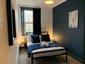 a bedroom with a bed with a teddy bear on it at Saltwell St - Delightful 3 Bedroom free parking free wifi in Gateshead