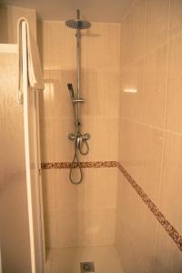 a shower with a shower head in a bathroom at Hostal La Toba in Cañete