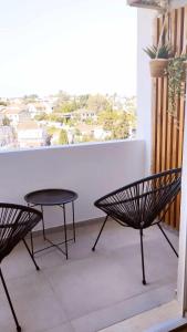 a table and two chairs on a balcony with a window at inas 2 bedroom apartment in Lefkimmi