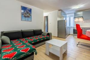 a living room with a couch and a table at Apartman Robert Cres in Cres