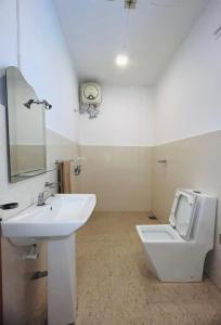 a bathroom with a white sink and a toilet at Heritage Villa colombo7 in Colombo