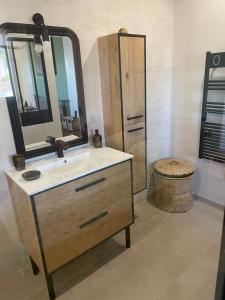 a bathroom with a sink and a mirror at Location Furiani t2 de standing in Furiani