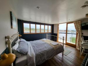 a bedroom with a bed and a large window at Inner Dowsing Lightship in Rochester