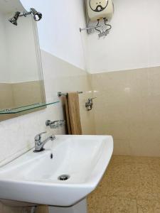 y baño con lavabo blanco y espejo. en Heritage Villa colombo7 en Colombo