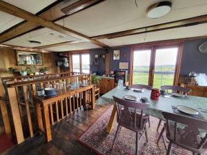 a dining room with a table and chairs at Inner Dowsing Lightship in Rochester