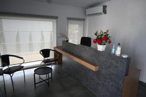 a room with a counter with chairs and a table at Hotel Sole in Durrës