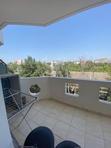 a balcony with chairs and a view of the city at Αρέθουσα easy view in Chalkida