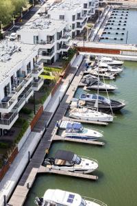 a group of boats docked in a marina with buildings at GRANO HOTEL Solmarina in Wiślinka