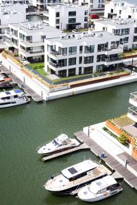 two boats are docked at a dock in the water at GRANO HOTEL Solmarina in Wiślinka
