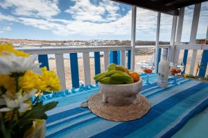 a bowl of fruit on a table with a view of the beach at Cabin in front of idyllic majanicho beach in Majanicho +20 photos