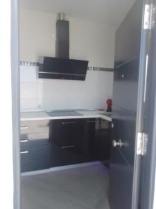kuchnia z czarno-białą kuchnią w obiekcie Apartamento relax con piscina y jacussy spa w mieście Chiclana de la Frontera