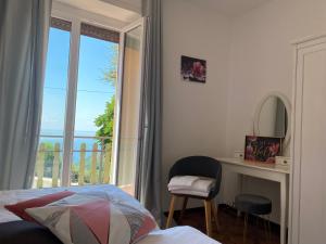 a bedroom with a bed and a desk and a window at Ca' ai Tigli in Tignale