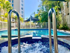 a swimming pool with a water slide in it at Charming Burleigh Studio in Gold Coast