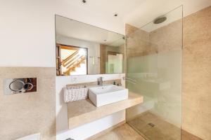 a bathroom with a sink and a mirror at Villa Antonia in El Port +24 photos
