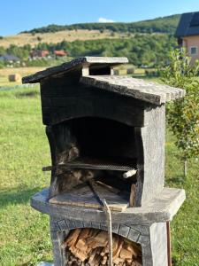 a wood fired oven sitting in a field at Sweet Dreams Home in Korenica