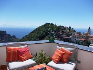 two chairs on a balcony with a view of the ocean at L'Arabesco B&B in Amalfi