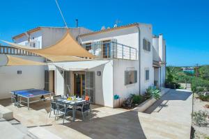 a large white house with a table and chairs at Ses Crestes in Portocolom