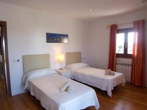 a hotel room with two beds and a window at Ses Crestes in Portocolom +22 photos