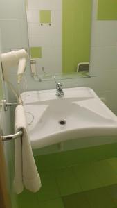 a bathroom with a white sink and a mirror at Hotel Sharing in Turin