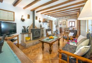 a living room with a tv and a fireplace at Can Reus by Vintage Travel in Pollença