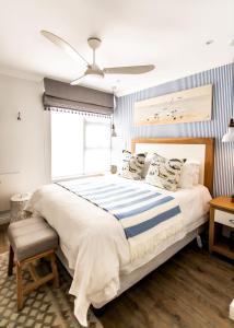 a bedroom with a large bed and a ceiling fan at Serendipity in Hermanus