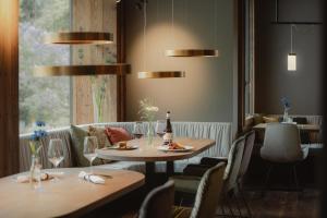 a restaurant with two tables and chairs and a window at Europe Hotel & Spa in Zermatt