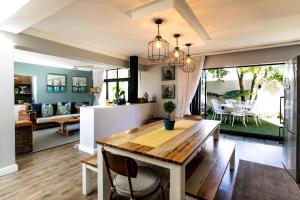 a dining room and living room with a table and chairs at Serendipity in Hermanus