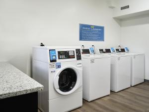 a washing machine and a washer and dryer in a room at stayAPT Suites Jackson in Jackson