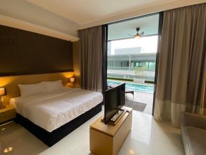 - une chambre avec un lit, une télévision et une fenêtre dans l'établissement Amanjiwa 99R, à Kampong Morten