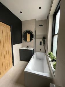 a bathroom with a large bath tub and a sink at Luxury 2 bed 1 bath in Central London by Graceful Apartments in London