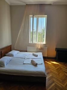 a bed in a room with a large window at Sweet Home Near Black Sea in K'obulet'i