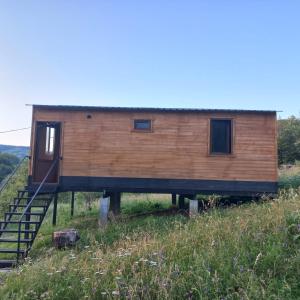 a tiny house on a hill with a staircase at cottage dzama 