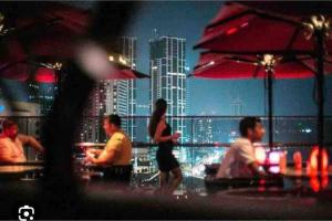 a group of people sitting at a bar with a city skyline at Next to Indian Ocean in Colombo
