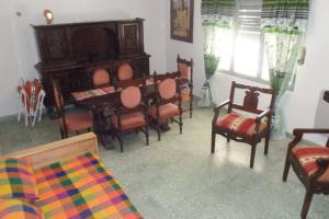 a living room with chairs and a piano and a table at Yala in Yala
