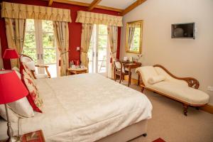 a bedroom with a large bed and a table and chairs at Mere Brook House in Wirral