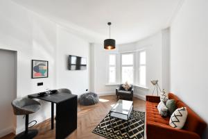 a living room with a couch and a table at Prestwick Green Pad in Prestwick