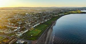 an aerial view of a beach and the ocean at Prestwick Green Pad in Prestwick