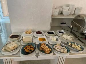 a table filled with different types of food on it at Reikartz Amirun Tashkent in Tashkent