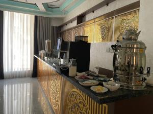 a kitchen with a counter with a coffee maker on it at Reikartz Amirun Tashkent in Tashkent