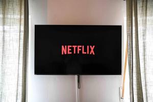 einen Fernseher mit dem Netflix-Schild an der Wand in der Unterkunft Moderne Wohnung in Ruhiger Umgebung nahe Messe in Berlin