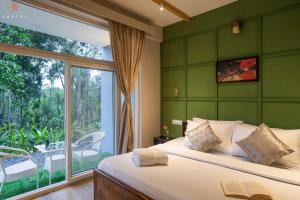 a bedroom with a bed and a large window at Zostel Coorg, Madikeri in Madikeri
