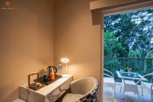 a room with a table and a chair and a window at Zostel Coorg, Madikeri in Madikeri