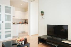 a living room with a large flat screen tv at 2 room suite in the heart of Zurich with own washing in Zurich