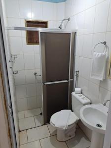 a small bathroom with a toilet and a sink at Pousada Do Mineiro in Olímpia