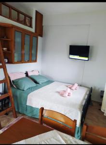 a bedroom with two beds with pink towels on them at Chris & Mary Comfort Rooms (country house) in Nea Iraklia