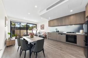 a kitchen and dining room with a table and chairs at modern 3 bedroom townhous in Ashfield in Sydney