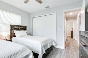 a white bedroom with two beds and a window at Murray Dale Hideaway in Valrico +41 photos