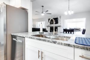 a kitchen with a sink and a fireplace at Murray Dale Hideaway in Valrico