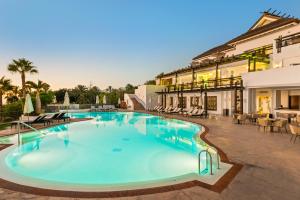 a large swimming pool next to a building at Las Terrazas de Abama Suites in Guía de Isora